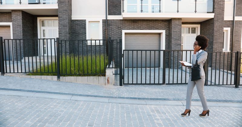 Real estate agent using Mojo app while door knocking in a neighborhood.